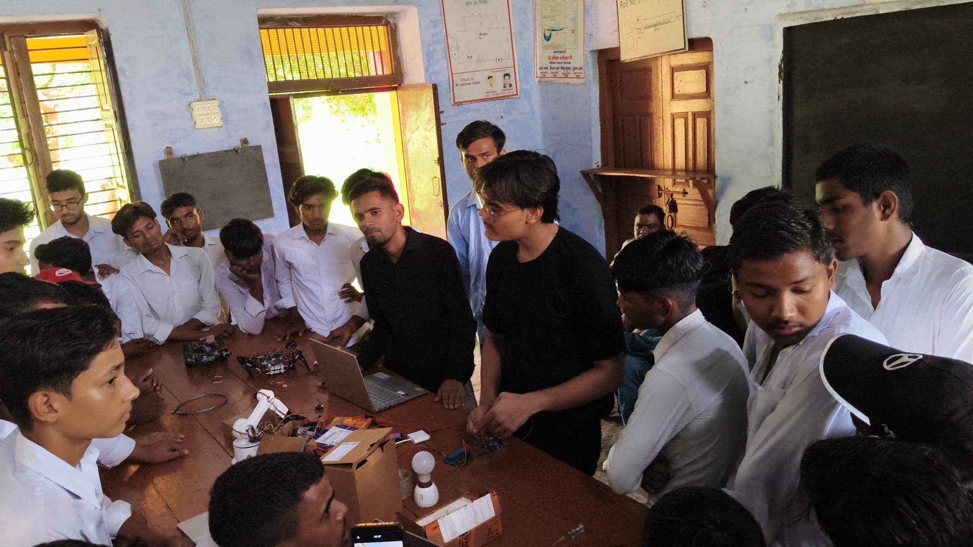 Mentors guiding students on microcontroller signals and motor control at Gopiram Paliwal Inter College