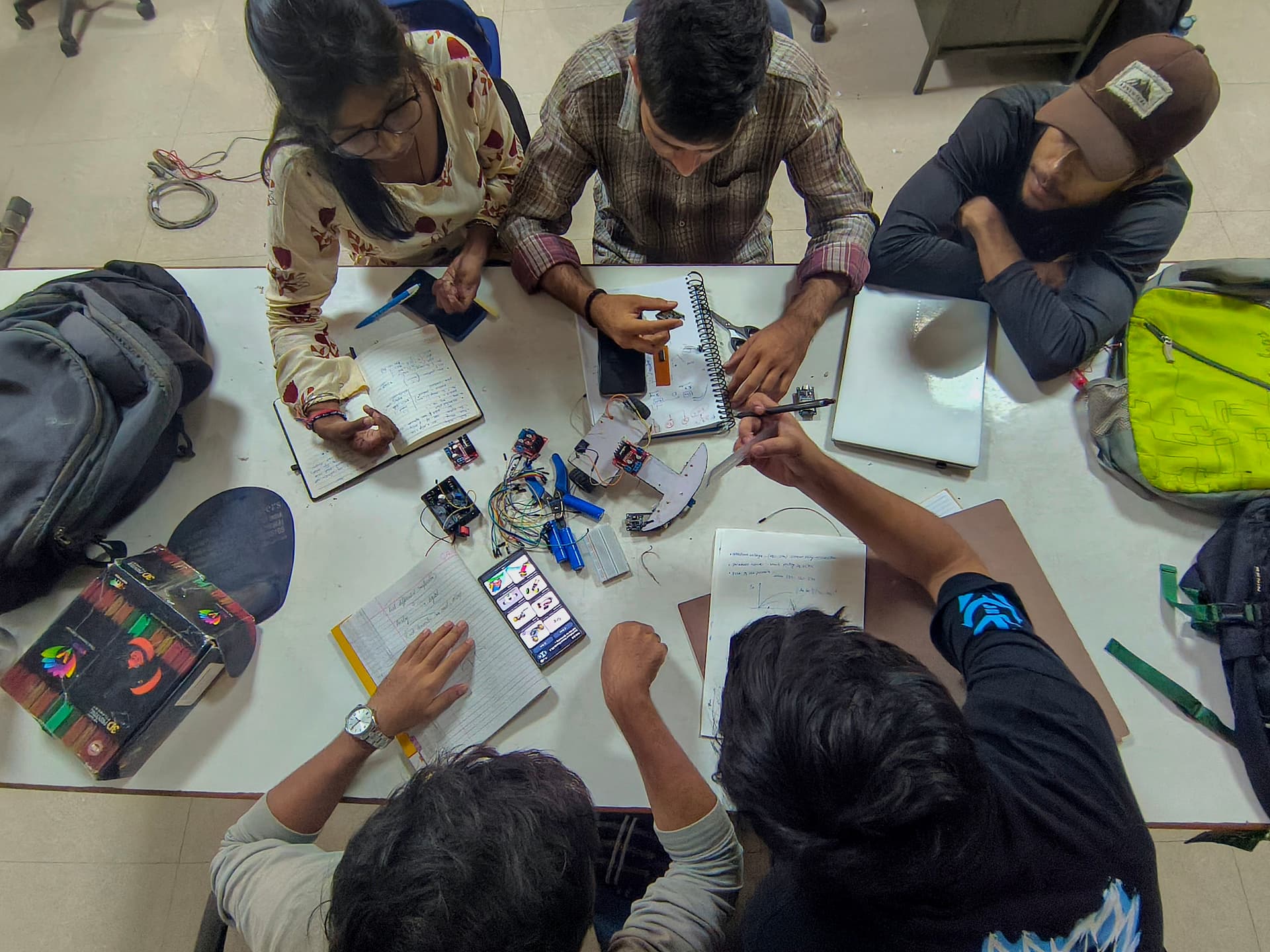 Team brainstorming, schematic notes, and sensor boom mechanical design