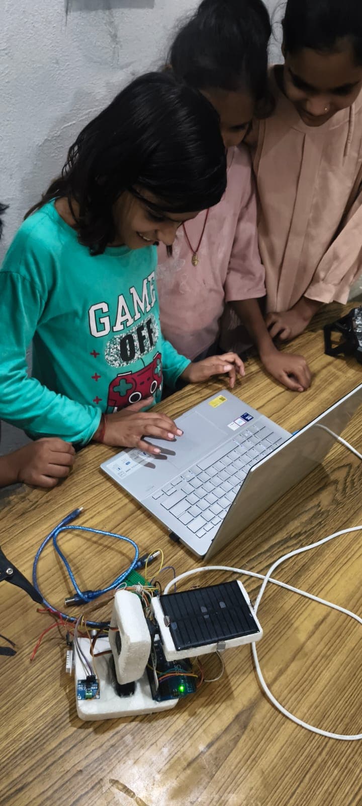 Students collaborating on a solar tracking robot build