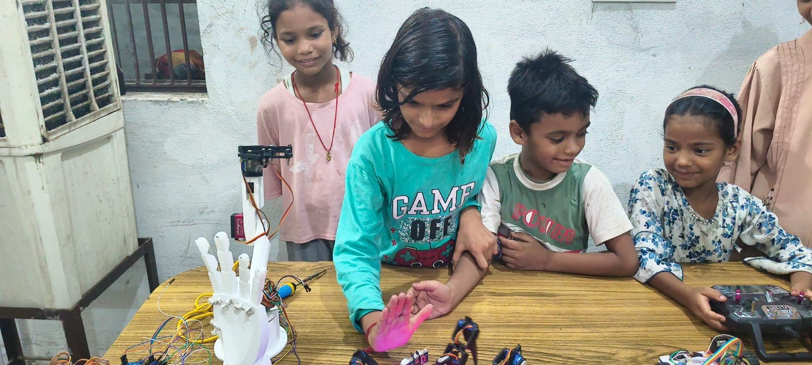 Students building a spider robot with mentorship