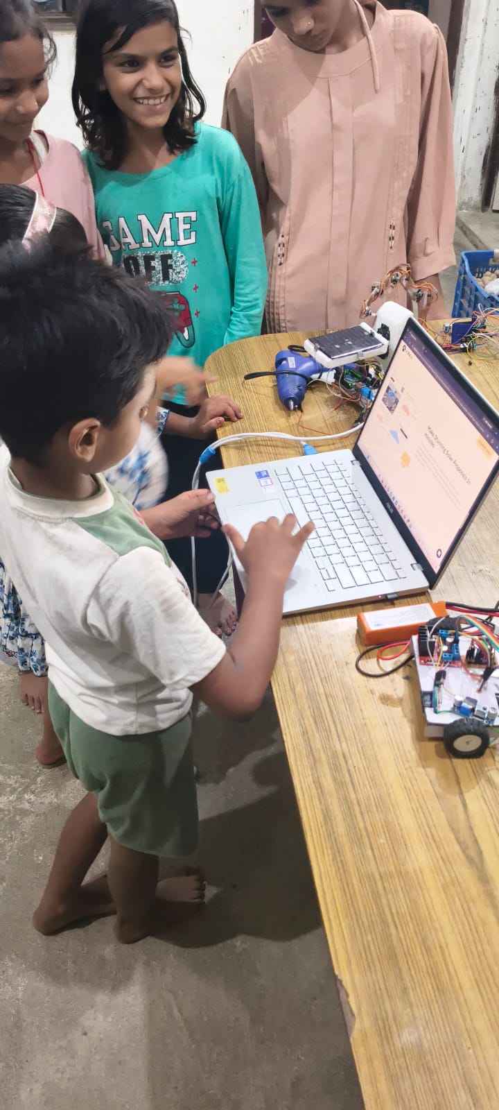 Young learners collaborating on practical electronics and robotics activities