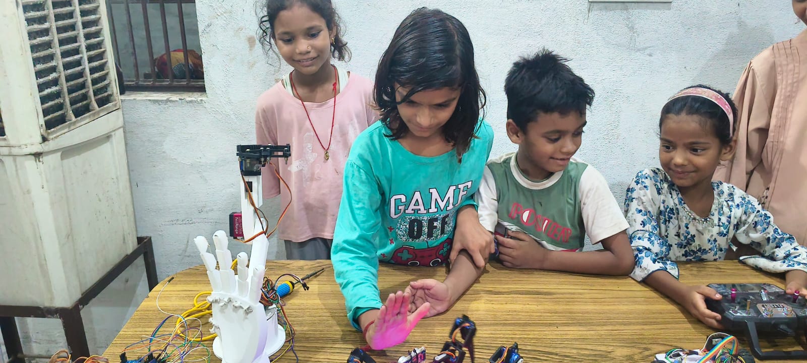Students engaging with mentors while discovering practical applications of electronics and technology